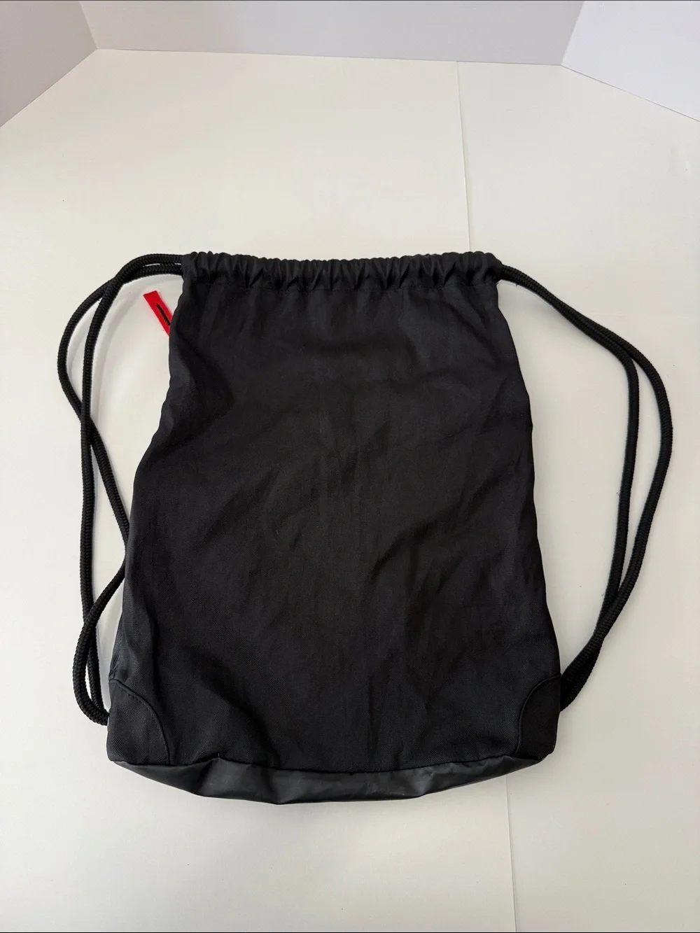 adidas Black Drawstring Backpack with Blue Stripes and Red Accents